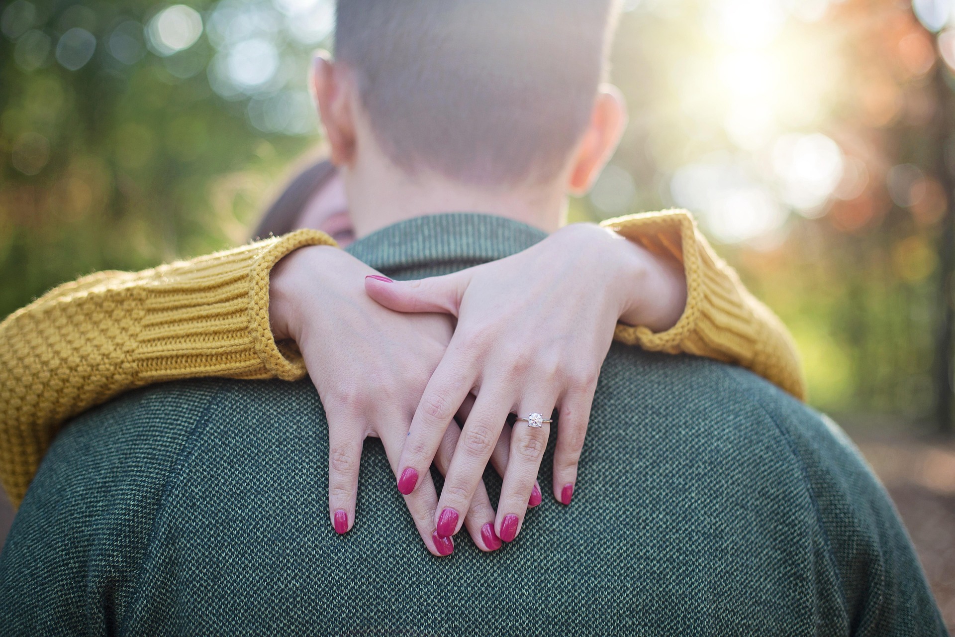 An engaged couple in love, arms around each other.