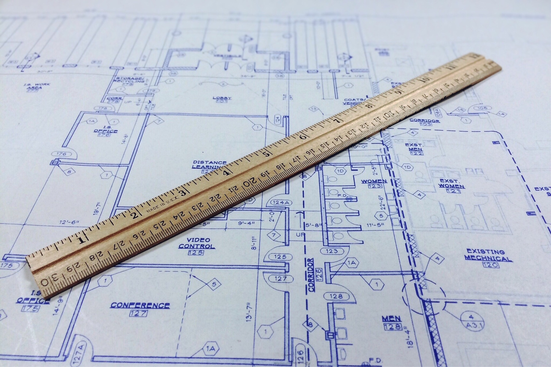 A blueprint with a ruler resting on top of the document.