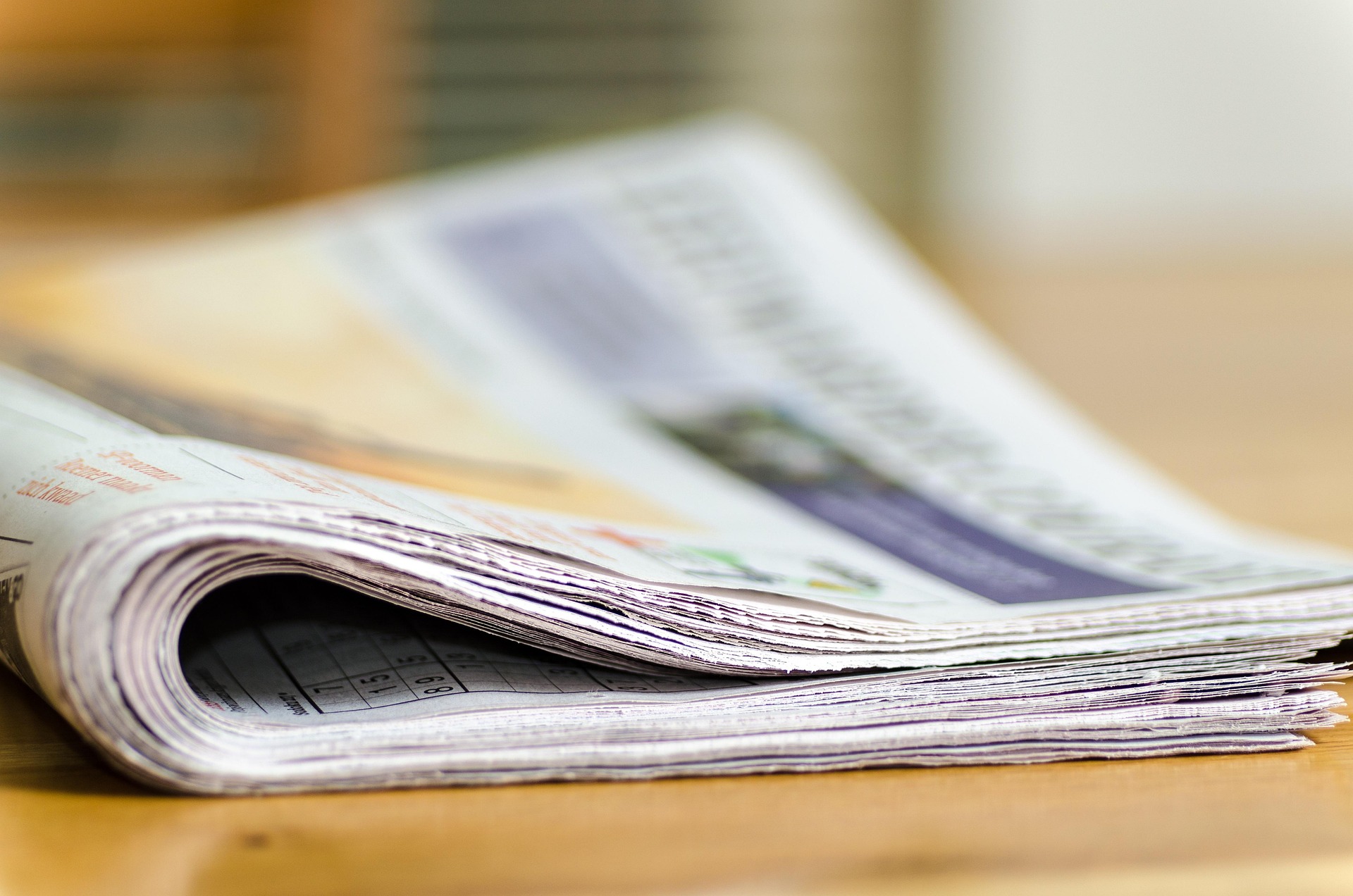 A folded newspaper on a table.