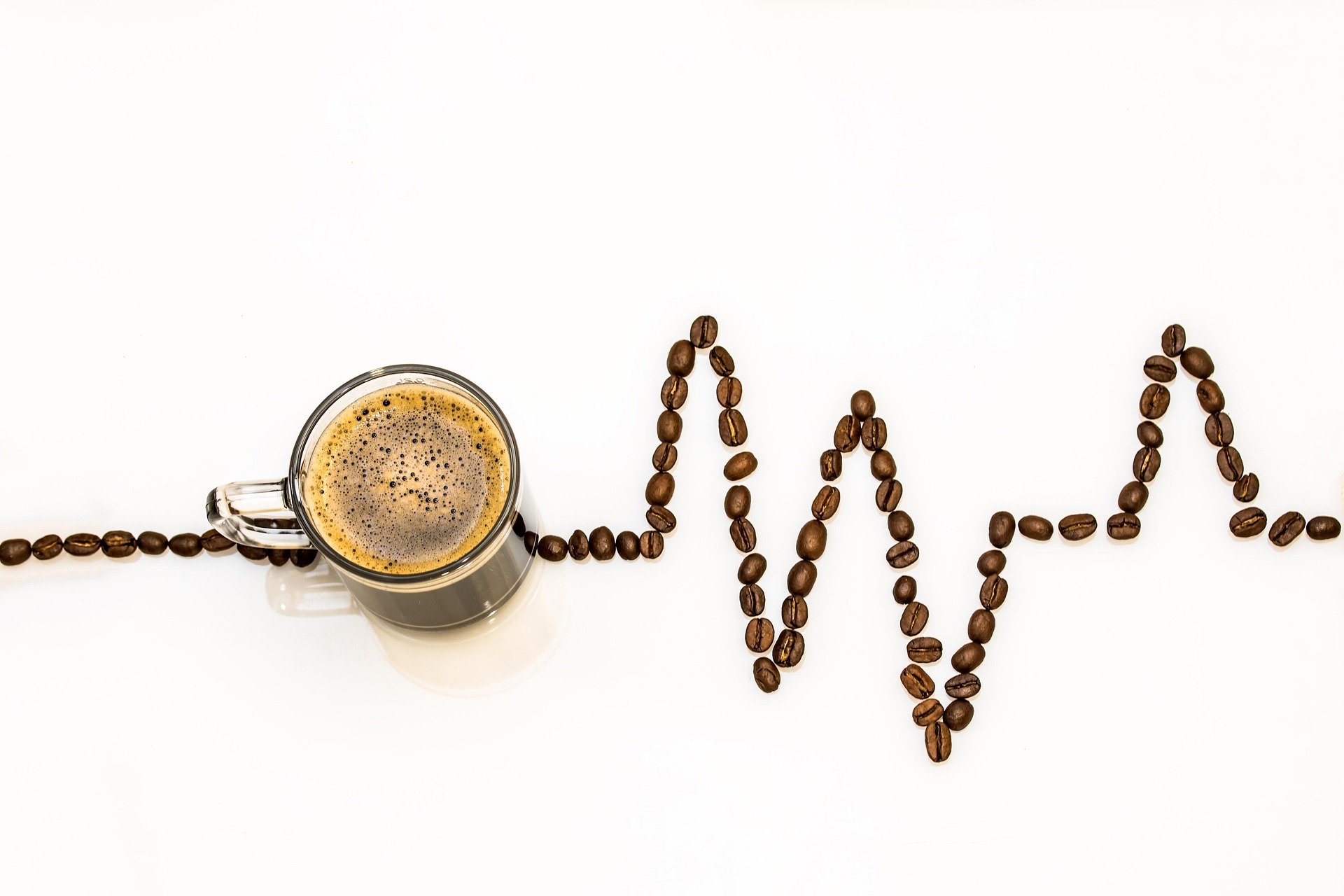 A cup of coffee and a 'chart' made of coffee beans.