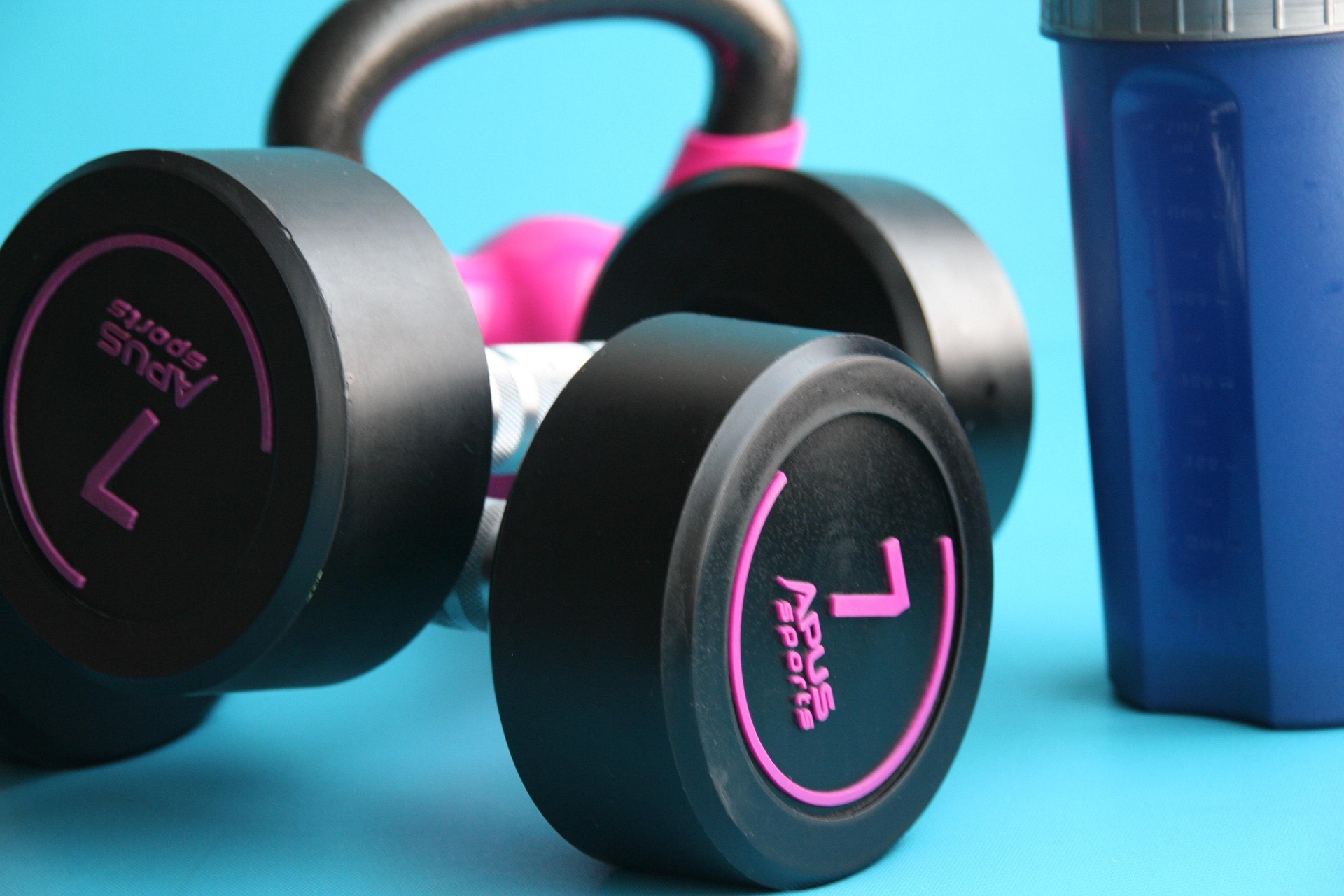 A set of fitness weights and a water bottle.