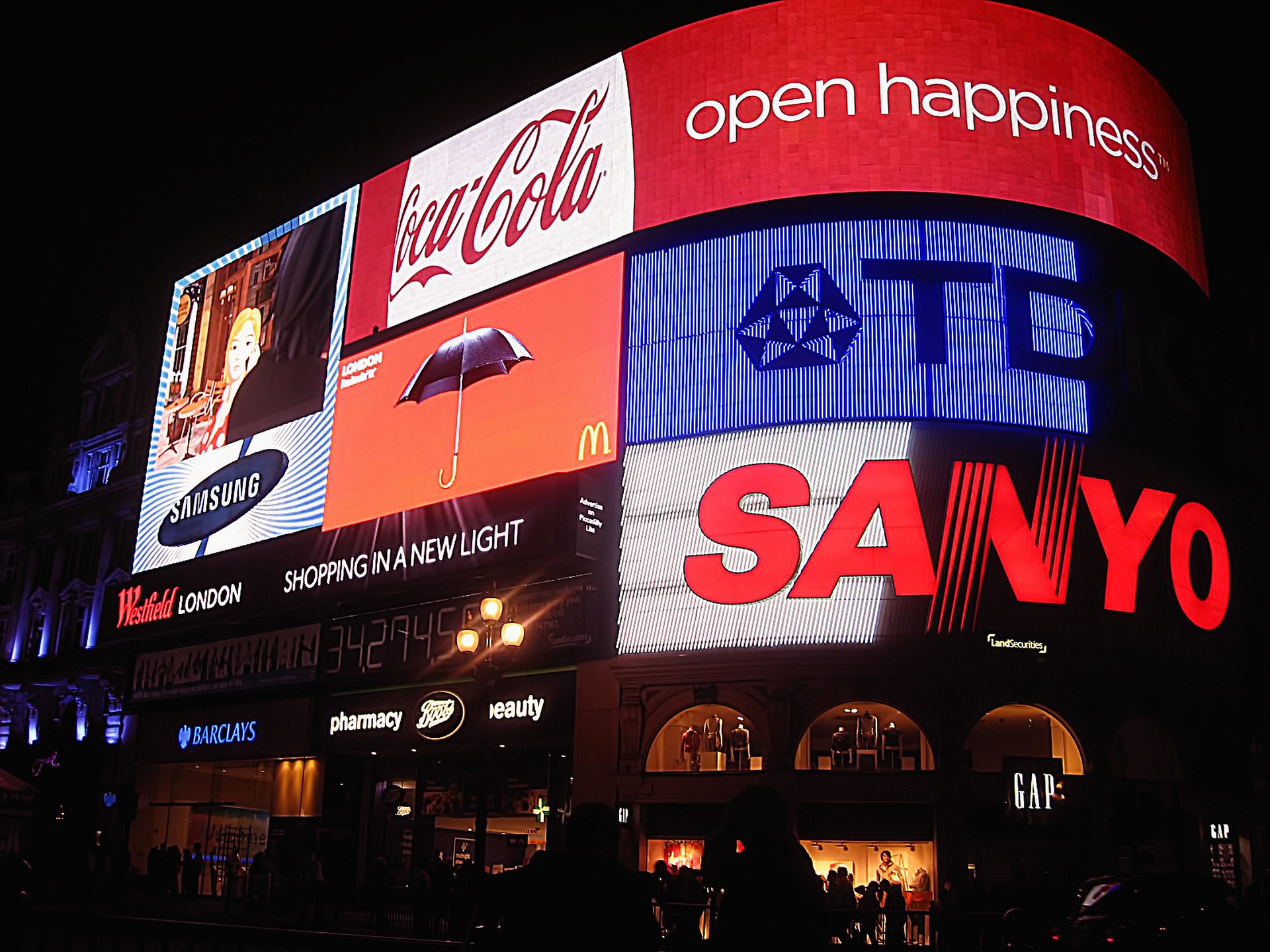 A variety of outdoor brand advertising on digital billboards.