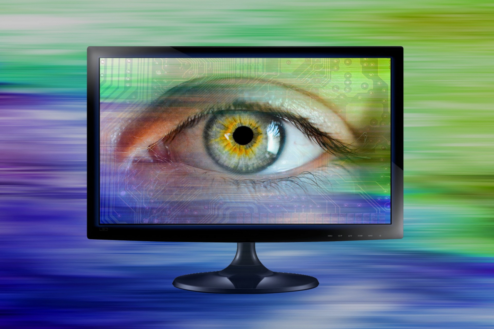 An eye on a computer monitor with colored background, symbolizing spyware.