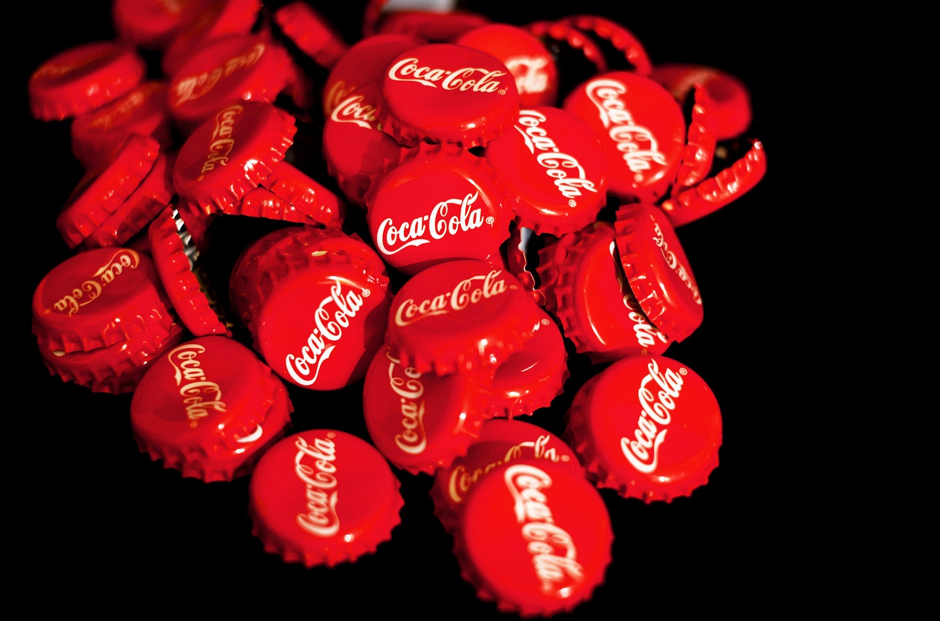A pile of bright red coca-cola bottle caps.