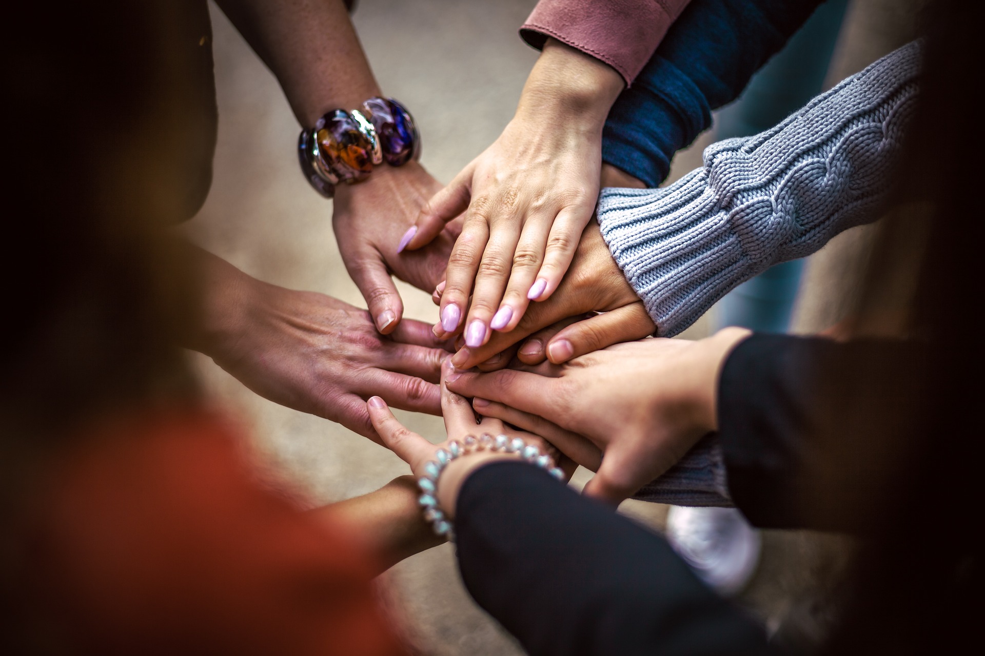 Putting your hands in together (team work).
