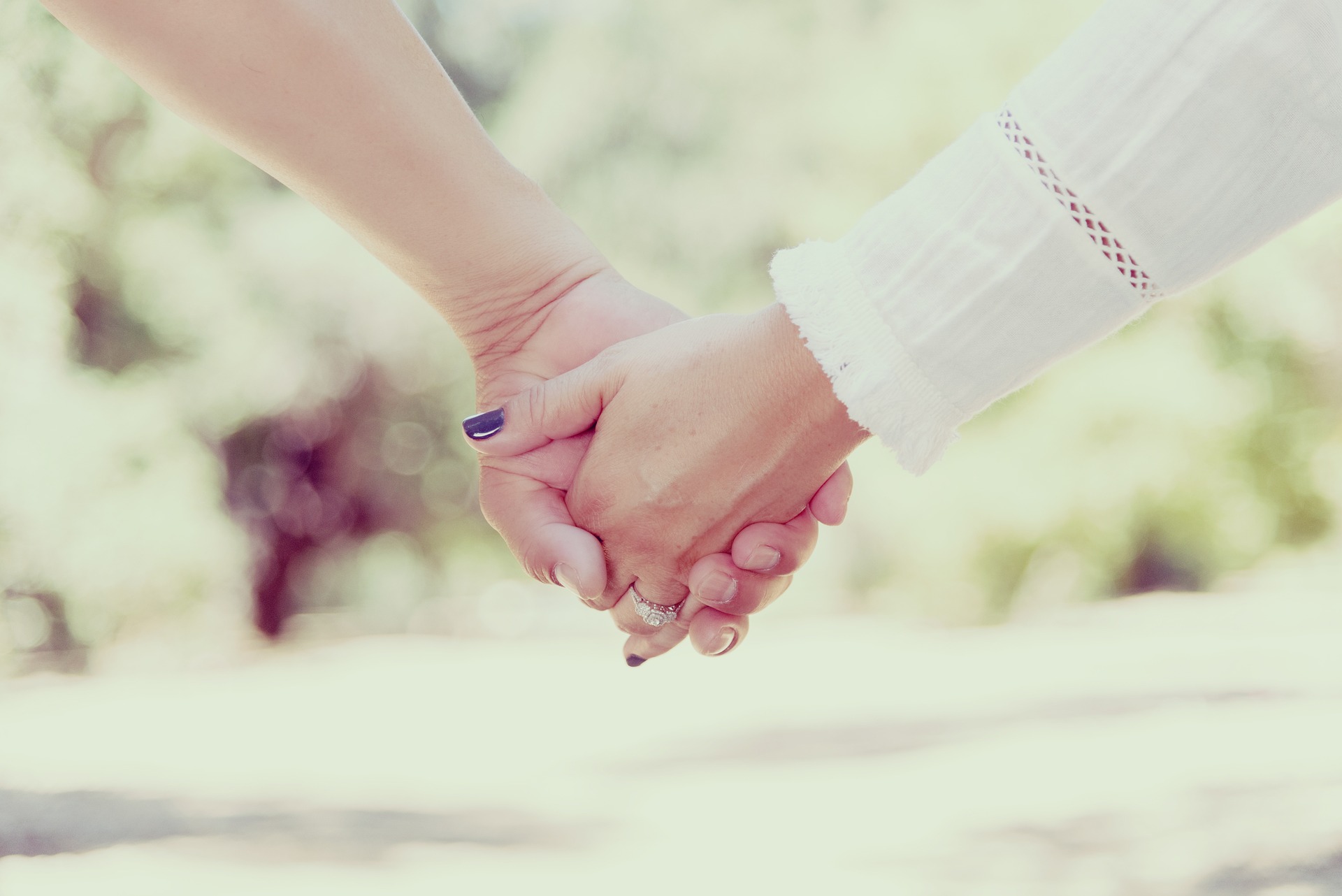 A couple holding hands showing the human element.