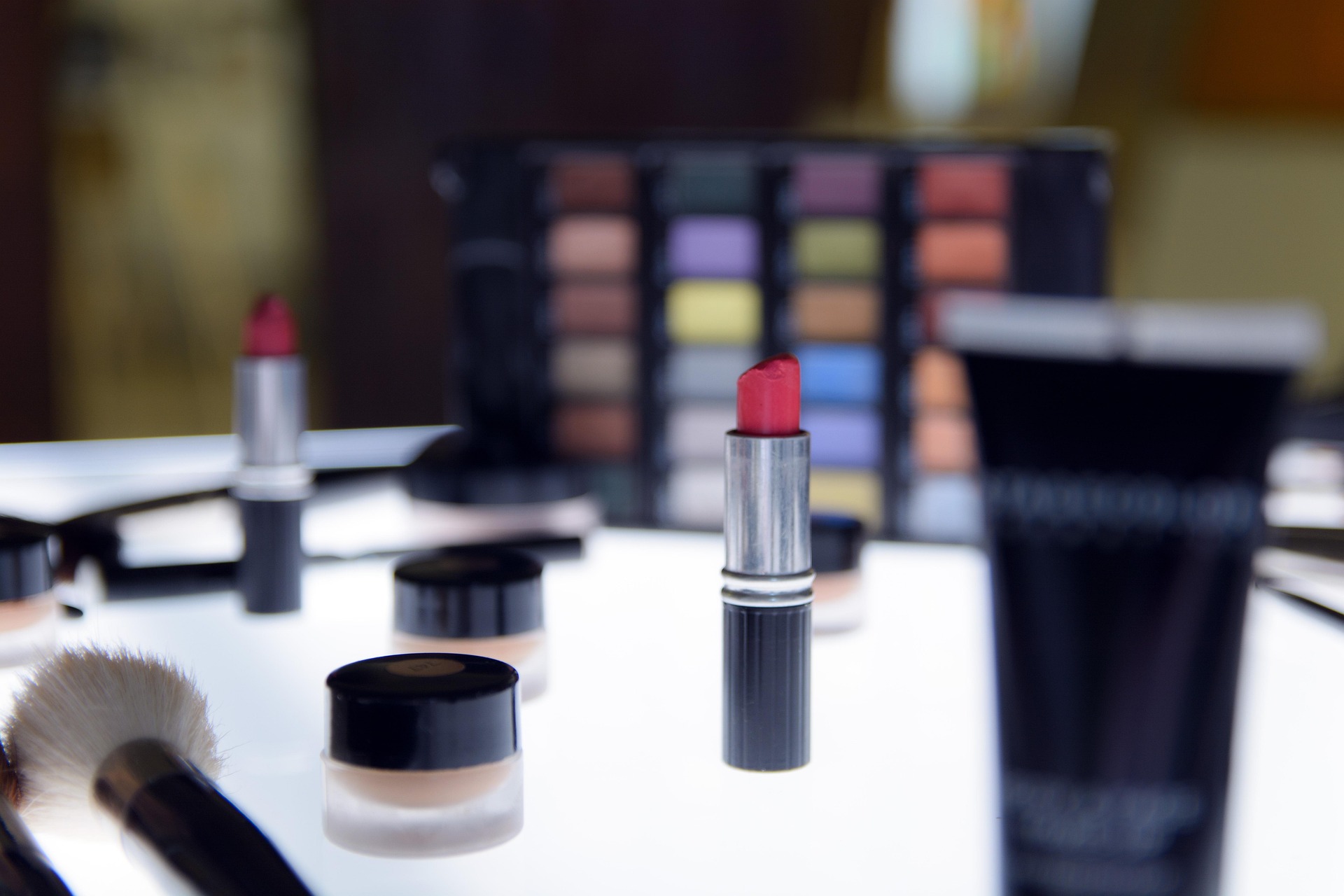 Lipstick and other beauty products on a counter.