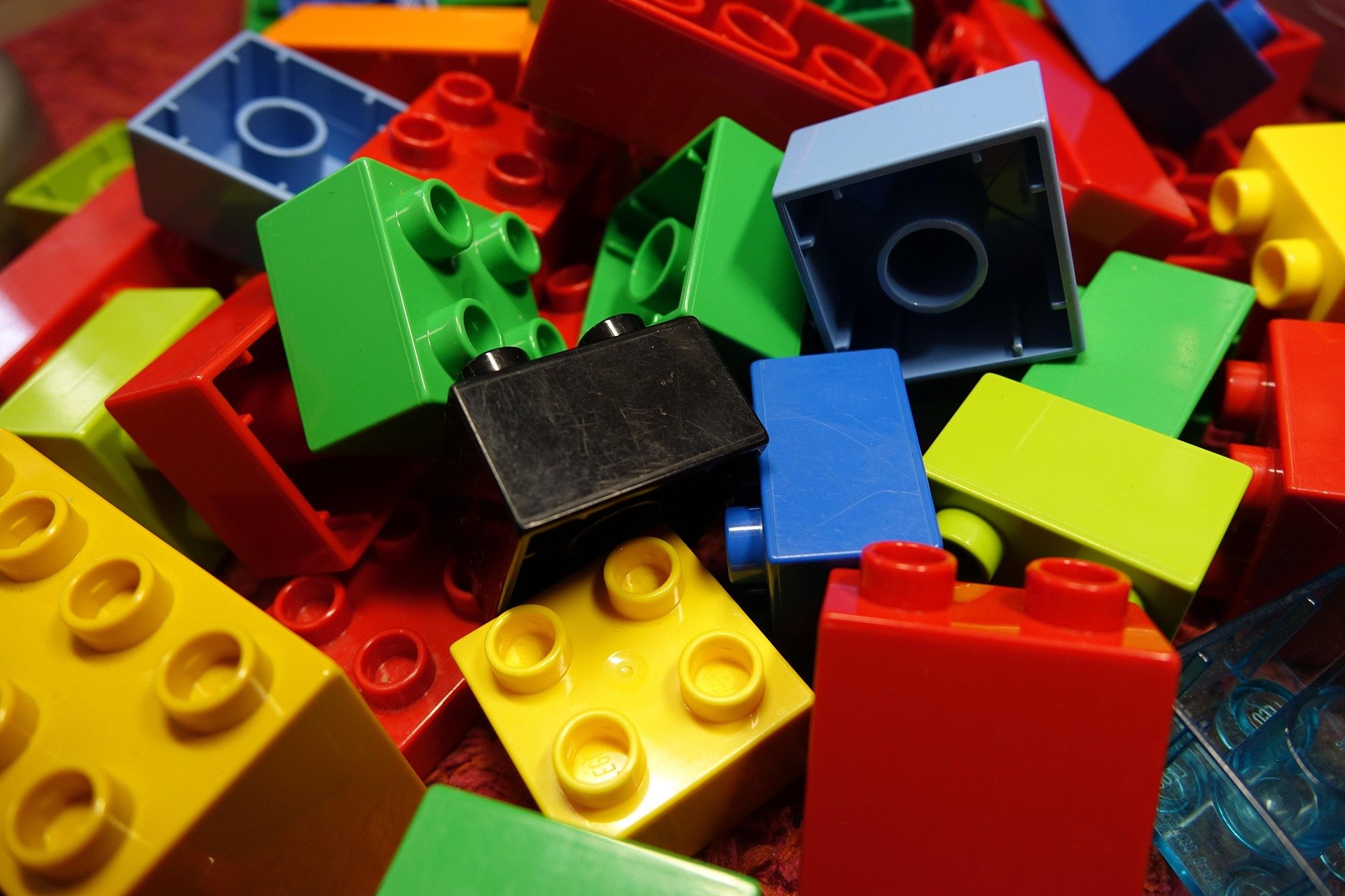 A colorful jumble of big Duplo Lego blocks.