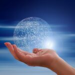 A outstretched hand holding a data sphere.