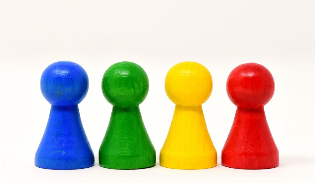 Four colorful game pieces standing in a row.