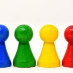 Four colorful game pieces standing in a row.