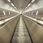 The perspective of going up or down a long escalator like in a subway.