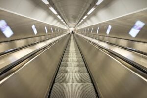 The perspective of going up or down a long escalator like in a subway.