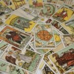 A variety of tarot cards spread out across a table.