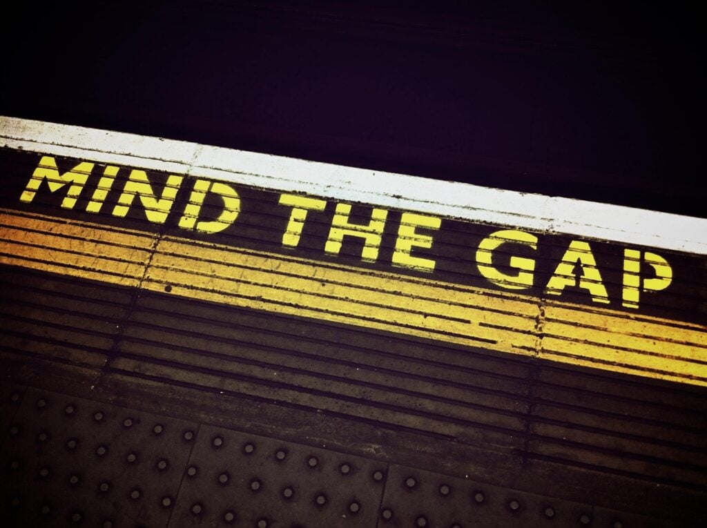 A 'Mind the Gap' sign on the floor of subway platform.