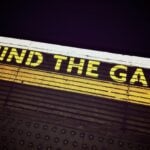 A 'Mind the Gap' sign on the floor of subway platform.