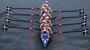 Competitive rowing team with paddles out and ready to row.