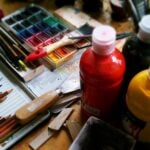 A mixed media palette of art and drawing/painting supplies.