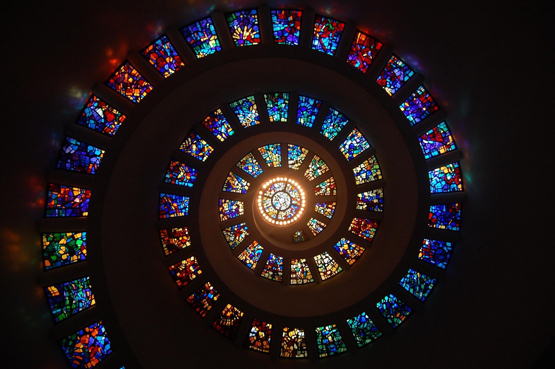 A stained-glass window spiraling from a center outward.