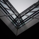 Interesting V angle/perspective looking up at an architectural glass building façade.