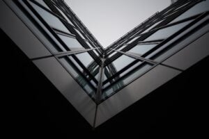 Interesting V angle/perspective looking up at an architectural glass building façade.