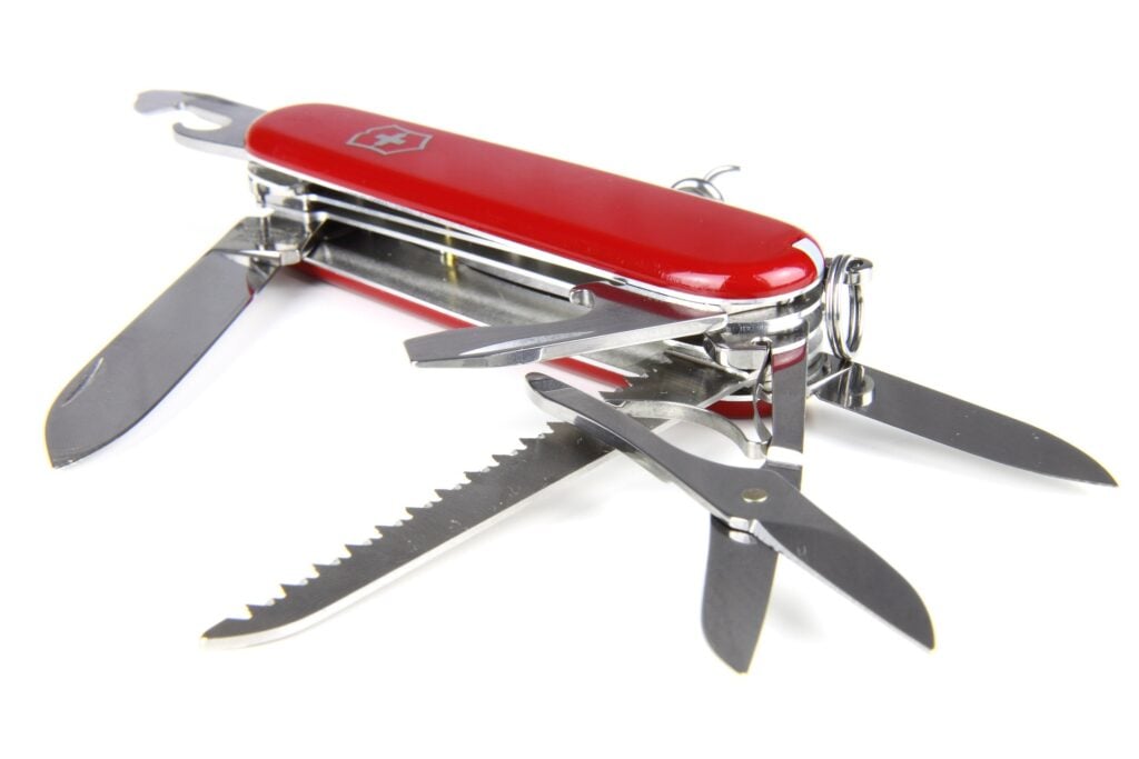 An iconic red Swiss Army knife opened to all its various tools and functions.