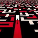 A graphic showing a person at the start of a large maze with many pathways.