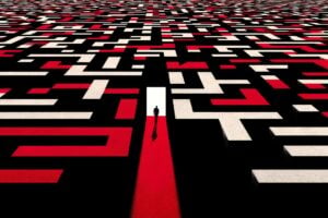 A graphic showing a person at the start of a large maze with many pathways.