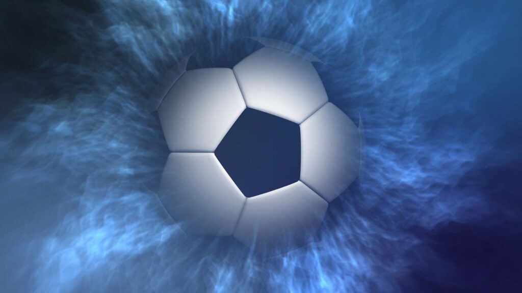 A soccer ball emerging from the fog and in the spotlight.