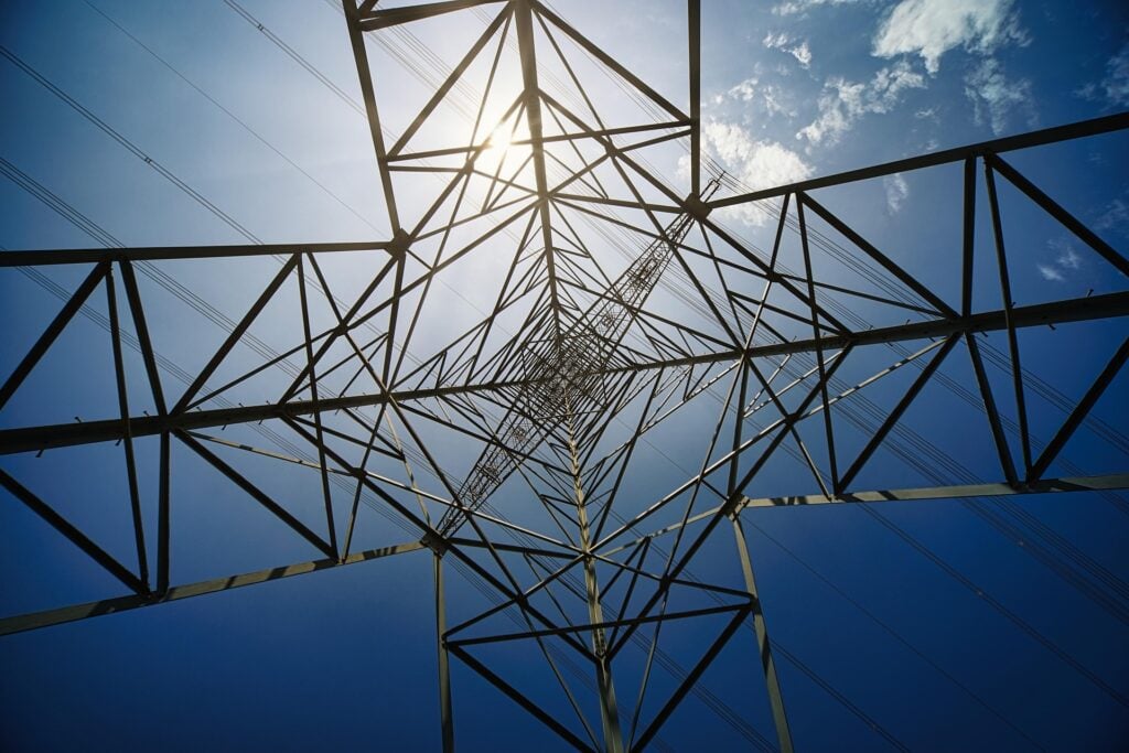 Angled perspective of a radio or signal tower with cables stretching out in all directions.