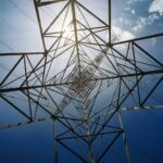 Angled perspective of a radio or signal tower with cables stretching out in all directions.