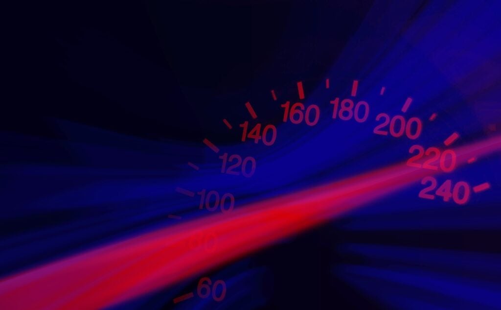 A speedometer with some laser effects showing high rates of speed.